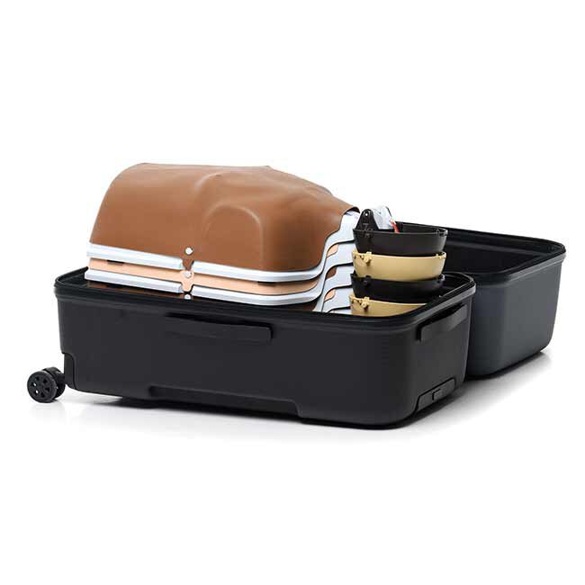 6 Brown and Tan Little Anne QCPR Enabled Adult CPR Manikins Stacked Together and Laying Flat in the Carrying Case.