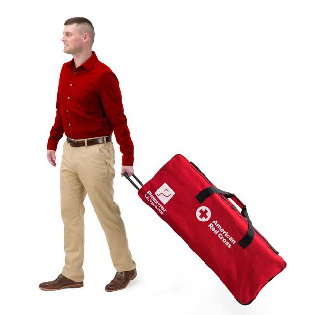 CPR instructor rolling the carrying case for the 12-pack Prestan Ultralite Diverse Skin-Tone Adult Manikins.