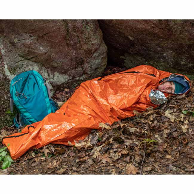 A person using the Survive Outdoors Longer (SOL) Emergency Bivvy.