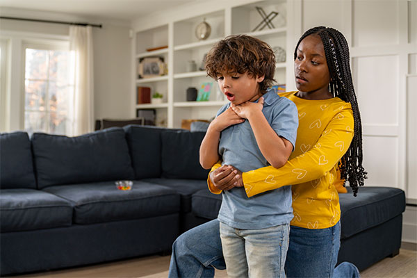 A babysitter helping a choking child by using techniques learned in the Glendale Babysitter Training course.